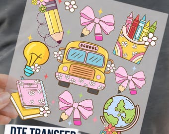 May include: A DTF transfer sheet featuring school-themed illustrations including a yellow school bus with the text SCHOOL, a yellow pencil, a globe, a box of colorful crayons, a lightbulb, notebooks, and pink bows, all decorated with small white flowers.
