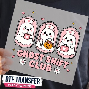 May include: A DTF transfer featuring three white ghost characters wearing pink nurse caps. One holds a pink mug, one a pumpkin bucket, and one a pink medical bag. The text reads GHOST SHIFT CLUB in pink letters, surrounded by small hearts, stars, and flowers.