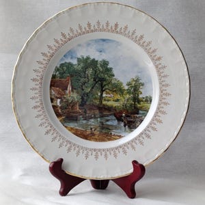 May include: A set of three ceramic mugs with a speckled, matte finish. The mugs are in shades of cream, light gray, and dark gray. Each mug has a simple, minimalist design and a rounded handle.