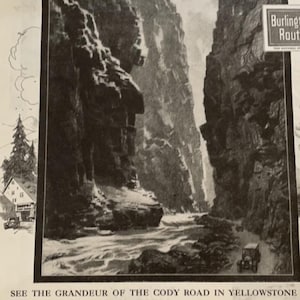 May include: Black and white vintage advertisement from The Saturday Evening Post. The image features a scenic view of a canyon road in Yellowstone National Park. Text includes "See the Grandeur of the Cody Road in Yellowstone."