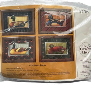 May include: A craft kit featuring four framed duck paintings. Each painting showcases a different duck design with detailed color and pattern work. The kit includes frames and instructions. The finished size for each painting is 5.75" x 7.75".