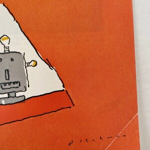 May include: A simple line drawing of a robot with two light bulbs on its head, standing on a red and white rug. The drawing is on a bright orange background with the text "w i e c h - m a s" in black at the bottom right corner.