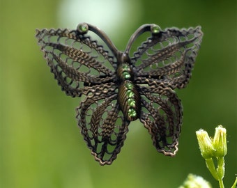 Detailed vintage filigree butterfly pin with tiny emerald green rhinestones