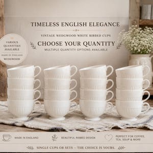 May include: Stacks of white, ribbed teacups with handles. The cups are arranged on a linen surface. Text on the image reads "Timeless English Elegance" and "Choose Your Quantity". The cups are from Wedgwood and are made in England.