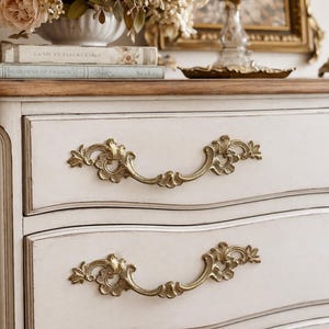 May include: A set of three ceramic mugs with a speckled, matte finish. The mugs are in shades of cream, light gray, and dark gray. Each mug has a simple, minimalist design, perfect for coffee or tea.