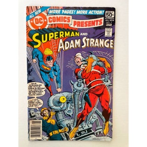 May include: A comic book cover featuring Superman and Adam Strange. The cover is blue, red, and yellow with the title "DC Comics Presents Superman and Adam Strange". The issue number is 3 and the cover price is 50 cents.