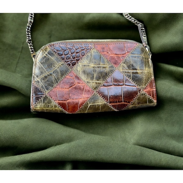 Versatile Clutch of embossed croc leather in a patchwork pattern featuring zig-zag stitch detail