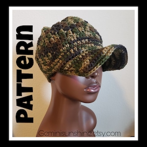 May include: A crocheted camouflage baseball cap with a brown, green, and black color scheme. The cap is worn on a mannequin's head. The text "Geminisunshine.etsy.com" is visible at the bottom of the image.