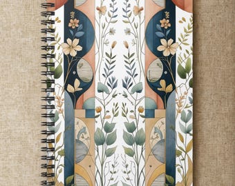 May include: Spiral-bound notebook with a watercolor design. The cover features a repeating pattern of botanical elements, including flowers and leaves, in shades of blue, orange, and green. The design is set against a white background.