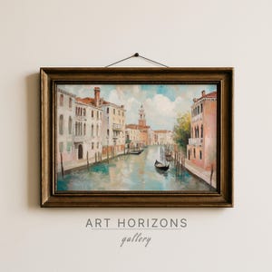 May include: Oil painting of a Venetian canal scene, framed in a gold-toned ornate frame. The artwork depicts buildings lining the canal, with gondolas and a distant tower. The sky is blue with fluffy clouds. The text "ART HORIZONS gallery" is at the bottom.
