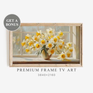 以下が含まれることがあります： 窓辺に置かれた、白と黄色の水仙が活けられた花瓶の額装された絵画。「PREMIUM FRAME TV ART」と表示され、解像度は3840x2160。左上には「GET A BONUS」と書かれた丸いステッカーがあります。