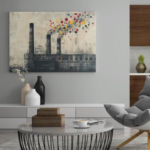 以下が含まれることがあります： 3本の煙突を持つ工場を描いた絵画。煙突からは花のようなカラフルな煙が出ています。絵画は、コーヒーテーブルと椅子のあるモダンなリビングルームに飾られています。