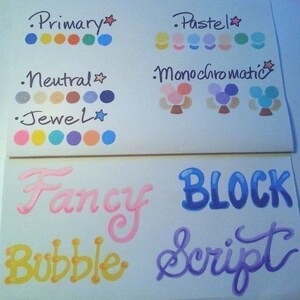 May include: A white sheet of paper with color swatches labeled "Primary", "Pastel", "Neutral", "Jewel", "Monochromatic", "Fancy", "Block", "Bubble", and "Script".