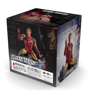 May include: A red and gold Iron Man action figure in a kneeling pose. The figure is holding a repulsor beam in its right hand. The figure is on a rocky base. The box is labeled "Iron Man" and has a warning label for choking hazards.