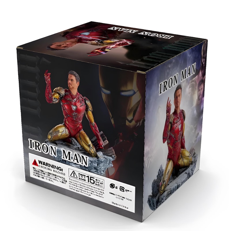 May include: A red and gold Iron Man action figure in a kneeling pose. The figure is holding a repulsor beam in its right hand. The figure is on a rocky base. The box is labeled "Iron Man" and has a warning label for choking hazards.