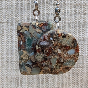 May include: Two decorative, round and rectangular,  light green, brown, and white patterned,  stone-like,  pull chains with silver metal chains.