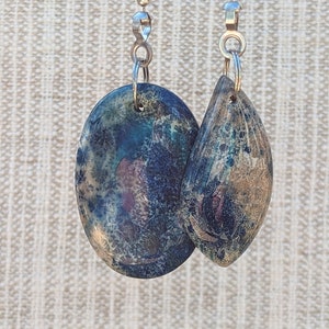 May include: Two decorative, oval-shaped, blue, green, and brown pull chains with silver chains.