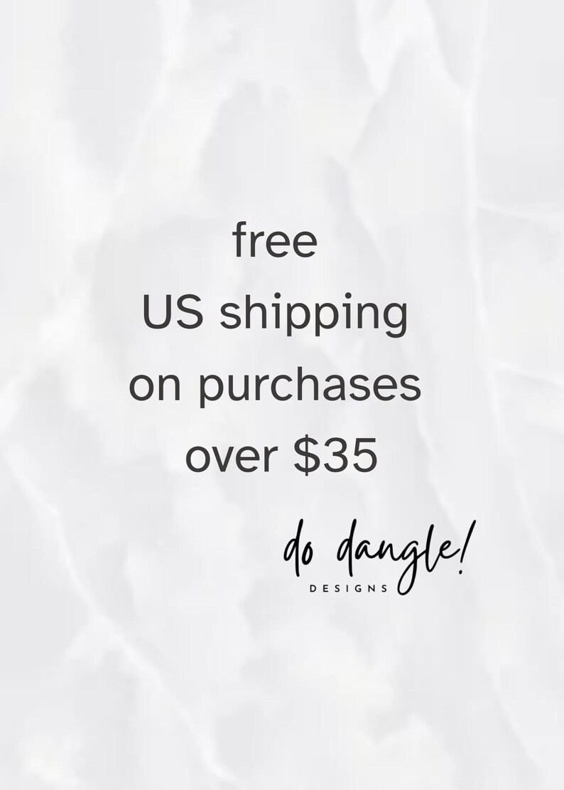 May include: A white and light gray marble-textured background featuring the black text "do dangle! DESIGNS" centered near the bottom. The design is clean and minimalist, focusing on the brand name presented in a combination of script and sans-serif fonts.