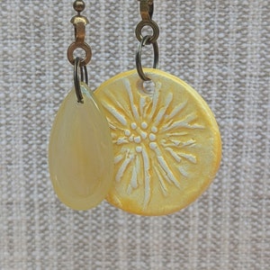 May include: A white ceramic mug with a black handle and the text "But First, Coffee" in a bold, black font. The mug is set against a neutral background, highlighting its simple design.