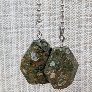 May include: A white ceramic mug with a black handle and the text "But First, Coffee" in a handwritten style. The mug is on a white surface. The mug is approximately 4 inches tall.