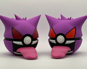 May include: Two purple and black Pokemon figures of a Ghost-type Pokemon with red eyes and a Pokeball design. The figures have pink tongues sticking out.
