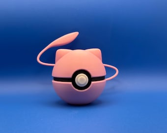 May include: A pink, spherical object with a black band and white button, resembling a cartoon character. It has two curved, pink handles and a pink, leaf-shaped element extending from the top. The background is a solid blue.