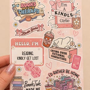 May include: A sticker sheet featuring various book-themed illustrations and text including Books are my therapy, I'm a Kindle Girlie, Hello I'm reading kindly get lost, Crying over fictional characters, BookTok made me read it, and I'd rather be home finishing my TBR pile.