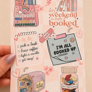 May include: A sticker sheet with a light pink checkered background featuring various illustrations including a tote bag with books, text reading "my weekend is fully booked", a "to do" list, a sticky note saying "I'M ALL BOOKED UP", a mailbox, and a jar labelled "Anti Depressants" filled with books.