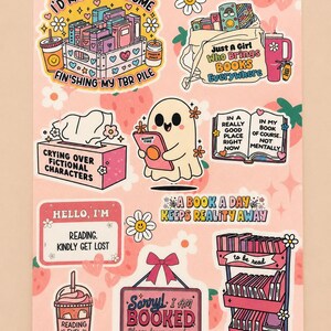 May include: A sticker sheet featuring various illustrations with book-themed text including I'D RATHER BE HOME, JUST A GIRL WHO BRINGS BOOKS EVERYWHERE, CRYING OVER FICTIONAL CHARACTERS, IN A REALLY GOOD PLACE RIGHT NOW, A BOOK A DAY KEEPS REALITY AWAY, and SORRY! I AM BOOKED.