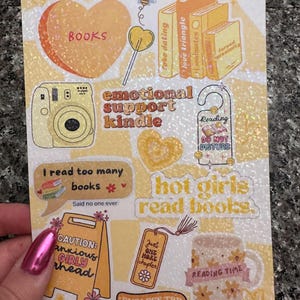 May include: A set of colourful stickers with a book theme. The stickers feature phrases like "Books", "Emotional Support Kindle", "Hot Girls Read Books", and "Endless TBR".