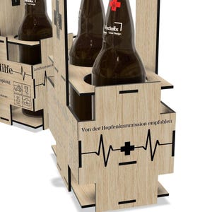 a wooden crate or holder with several bottles inside. The crate has a design that includes a heart symbol and text, suggesting a medical or healthcare theme.