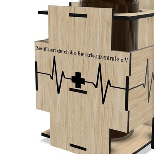 a wooden object with a heart-shaped symbol and text on it.