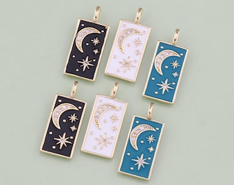 May include: Five gold-tone charms with a crescent moon and star design. The charms are rectangular and have a black, white, or blue enamel background. Each charm has a small loop at the top for attaching to a necklace or bracelet.