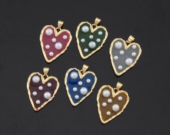 May include: Six gold heart-shaped pendants with different colored enamel and white pearl accents.