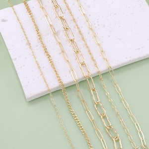 May include: A set of six gold chain necklaces with different link styles, including a delicate chain, a curb chain, and a chunky chain.