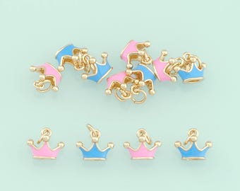 May include: A set of 10 gold-tone crown charms with blue and pink enamel. The charms are perfect for adding a touch of whimsy to jewelry or crafts.