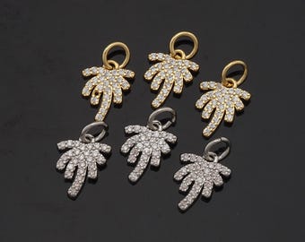May include: Six gold and silver palm tree charms with clear crystal accents. The charms are perfect for adding a tropical touch to jewelry.