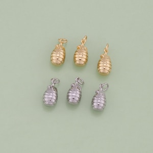 May include: Six gold and silver pineapple charms. The charms are in the shape of a pineapple with a textured surface. The charms are perfect for adding a touch of tropical flair to your jewelry.