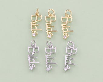 May include: Six gold and silver charms with the word "Bride" spelled out in cursive with a small rhinestone in the center of each charm.