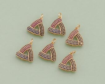 May include: Six gold triangle charms with pink and blue crystal accents. The charms are perfect for adding a touch of sparkle to jewelry projects.