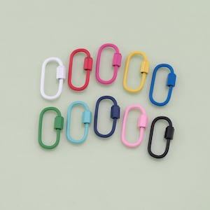 May include: Assortment of ten colourful oval-shaped metal clasps with a swiveling closure. The clasps are in various colours including white, red, pink, yellow, blue, green, and black.