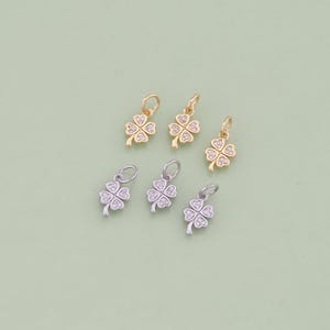 May include: Five gold and silver four-leaf clover charms with clear rhinestones. The charms are perfect for adding a touch of luck to jewelry projects.
