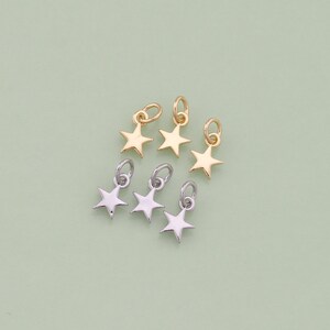 May include: Six gold and silver star charms with jump rings. The charms are perfect for adding a touch of sparkle to jewelry projects.