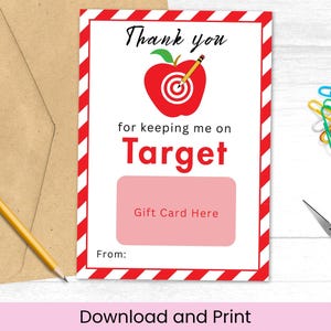 May include: A gift card with a red apple target design, the words "Thank you" and "for keeping me on Target". Includes a brown envelope, a pencil, colorful paper clips, and blue scissors.