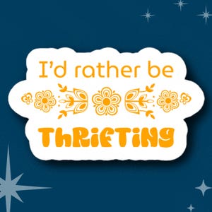 May include: White sticker with a yellow cloud shape. The text "I'd rather be thrifting" is in a yellow, retro font. The text is surrounded by a row of yellow flowers and leaves.