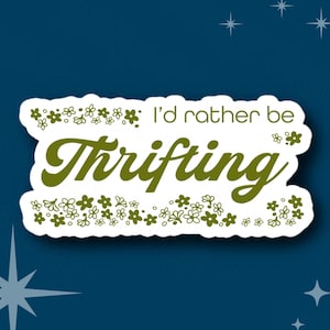 May include: White sticker with a green floral border and the text "I'd rather be thrifting" in green cursive font.