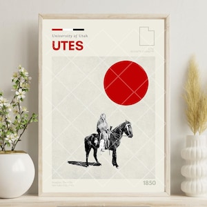 May include: Framed art print featuring a vintage-style illustration. The print includes the text "University of Utah UTES" in red, a red circle, and a black and white image of a person on a horse. The year 1850 is also displayed.