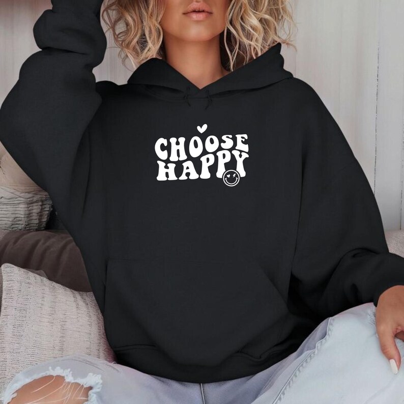 May include: Black hooded sweatshirt with the text "CHOOSE HAPPY" in white with a heart and a smiley face.