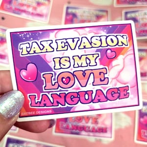 May include: A rectangular sticker with the text "TAX EVASION IS MY LOVE LANGUAGE" in a playful font. The sticker has a pink and purple gradient background with heart accents and a white border. The sticker is held by a person.