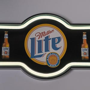 May include: A vintage Miller Lite beer sign with a black background and a white neon border. The sign features the Miller Lite logo in the centre and a bottle of beer on each side. The sign is plugged in.